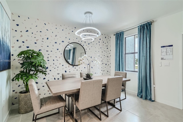 tiled dining room featuring a chandelier