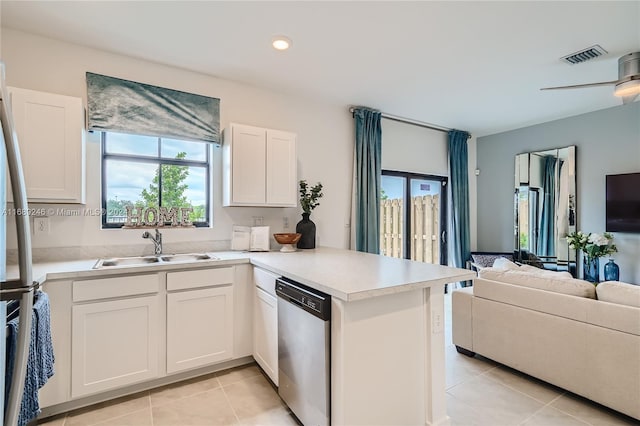 kitchen featuring dishwasher, kitchen peninsula, white cabinets, and light tile patterned floors