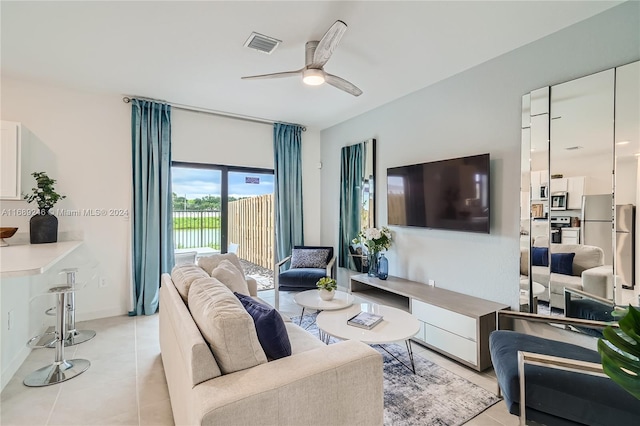 tiled living room featuring ceiling fan