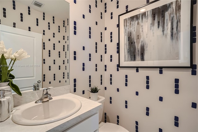 bathroom featuring vanity and toilet