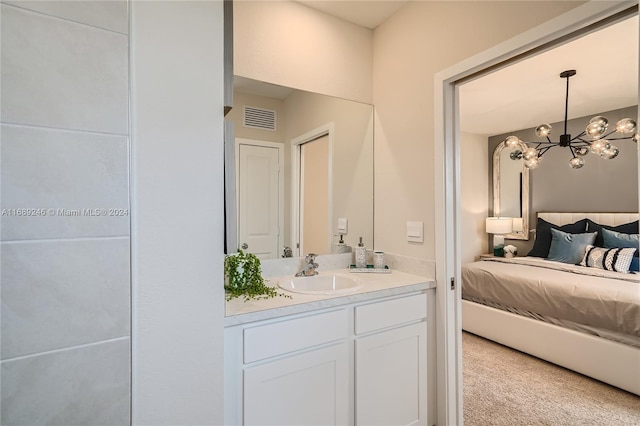 bathroom with vanity and a notable chandelier