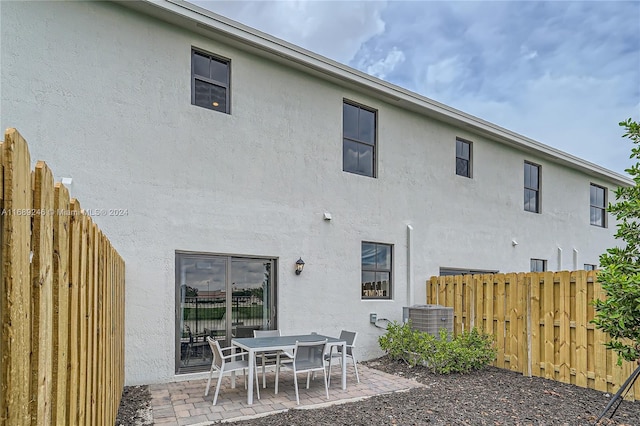 back of house with a patio area and central AC