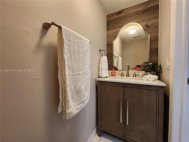 bathroom with vanity and wooden walls