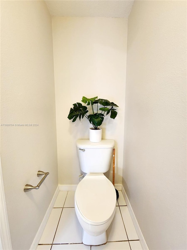 bathroom with toilet and tile patterned floors