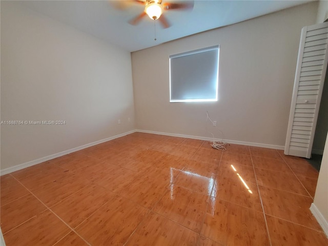 unfurnished bedroom with ceiling fan and tile patterned floors