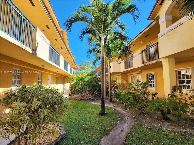 view of yard with a balcony