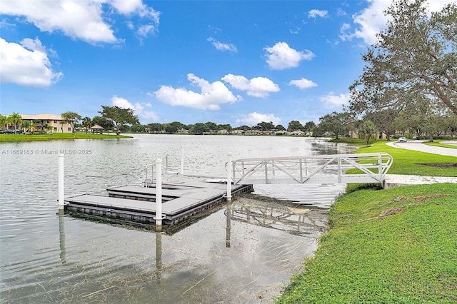 view of dock with a water view and a yard