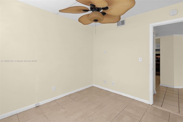 empty room featuring light tile patterned flooring and ceiling fan