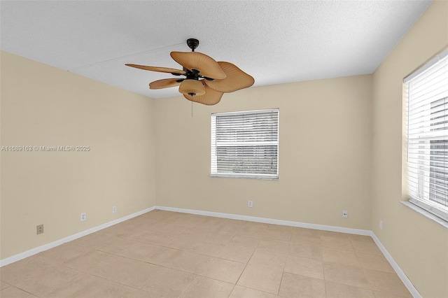 empty room with ceiling fan and a textured ceiling