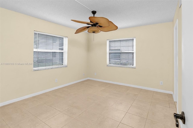 spare room featuring plenty of natural light, a textured ceiling, and ceiling fan