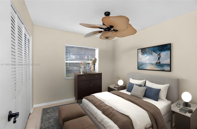 bedroom featuring light tile patterned floors, a closet, and ceiling fan