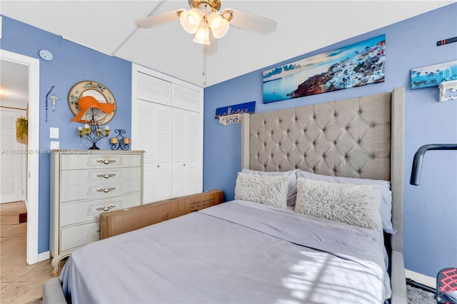 bedroom with ceiling fan, a closet, and light tile patterned floors