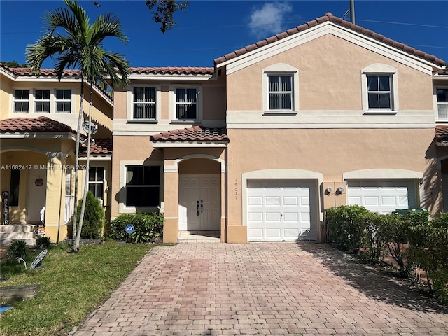 mediterranean / spanish home with a garage