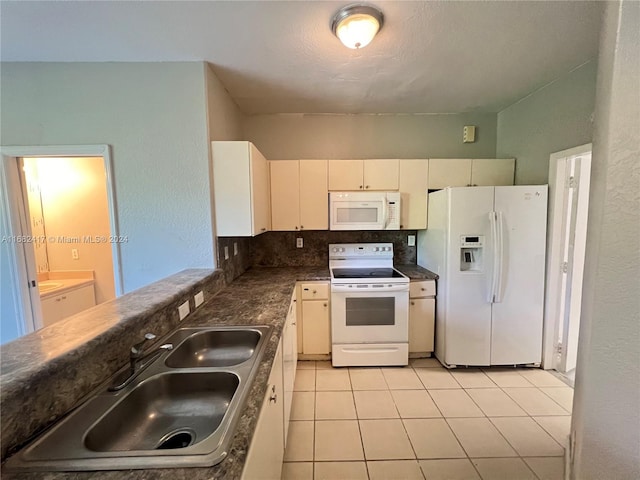 kitchen featuring tasteful backsplash, white cabinetry, light tile patterned floors, sink, and white appliances