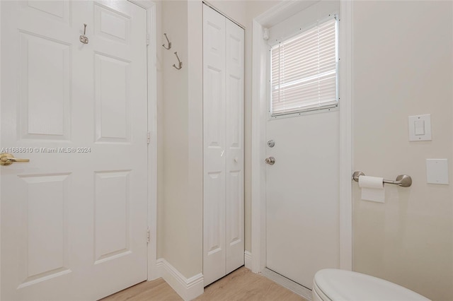 bathroom with toilet and hardwood / wood-style flooring