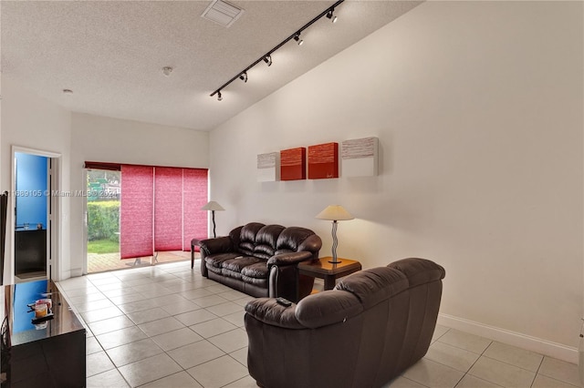 tiled living room with lofted ceiling and a textured ceiling