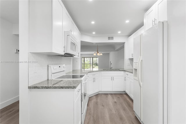 kitchen featuring kitchen peninsula, light wood-type flooring, white appliances, white cabinets, and pendant lighting