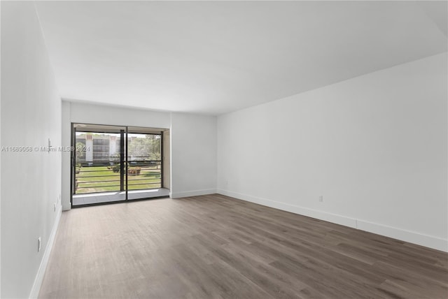 empty room with dark wood-type flooring