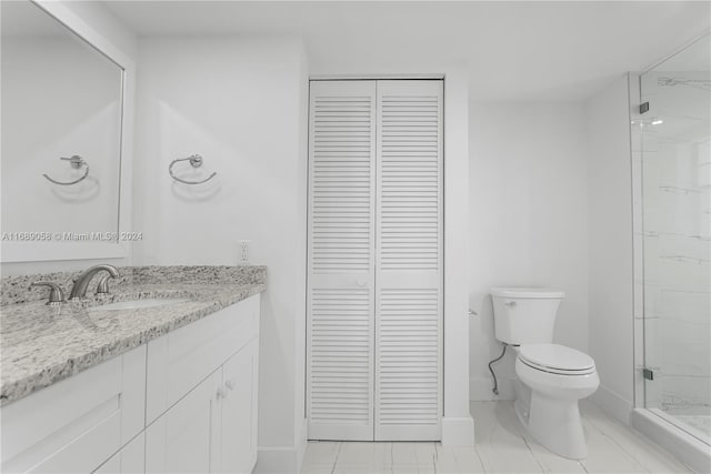 bathroom featuring walk in shower, vanity, and toilet