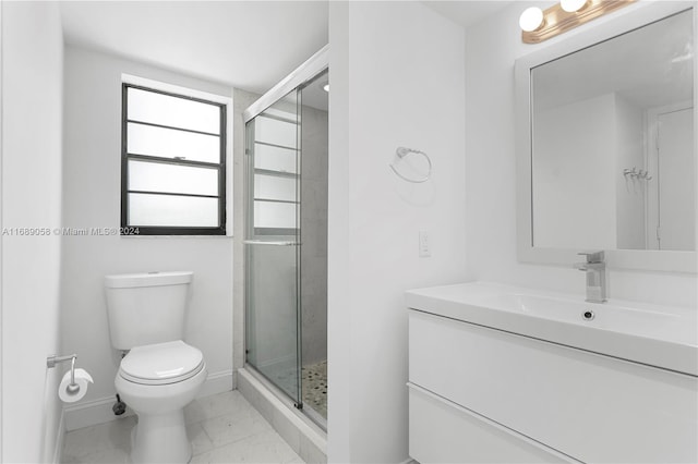 bathroom featuring vanity, toilet, and an enclosed shower