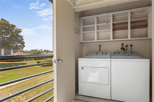 laundry area featuring light tile patterned floors and separate washer and dryer