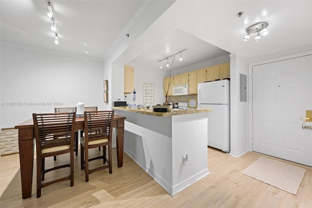 kitchen featuring light wood-type flooring, rail lighting, light brown cabinetry, and white appliances