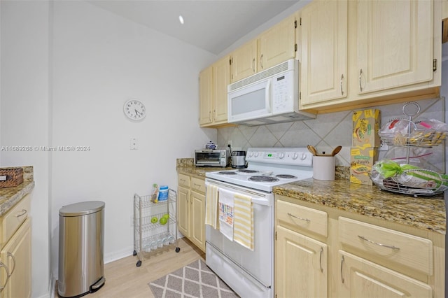 kitchen with light stone counters, backsplash, light wood-type flooring, light brown cabinets, and white appliances