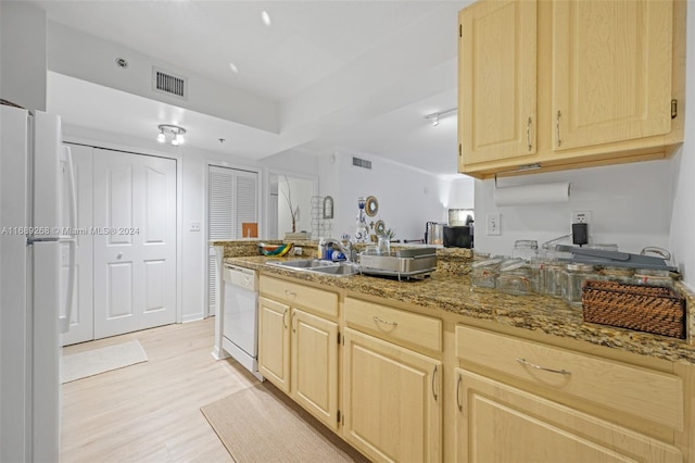 kitchen featuring sink, light stone counters, light brown cabinets, white appliances, and light hardwood / wood-style flooring