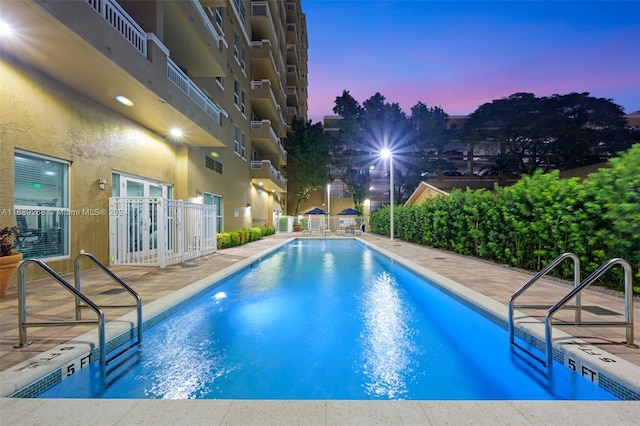 view of pool at dusk