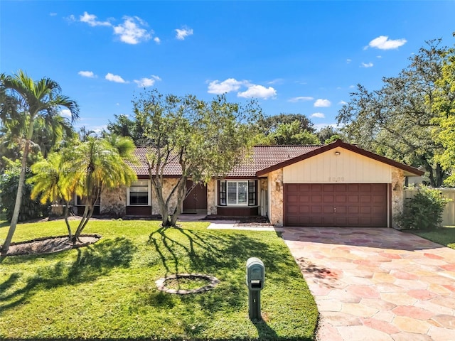 view of front of property featuring a garage and a front lawn