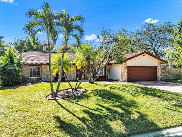 ranch-style home featuring a front yard and a garage