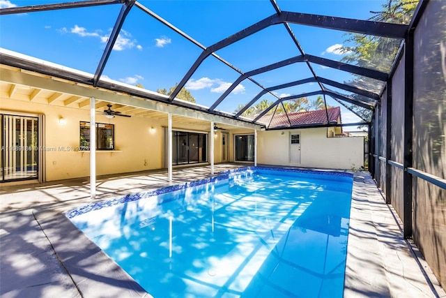 view of pool with a lanai, a patio area, and ceiling fan