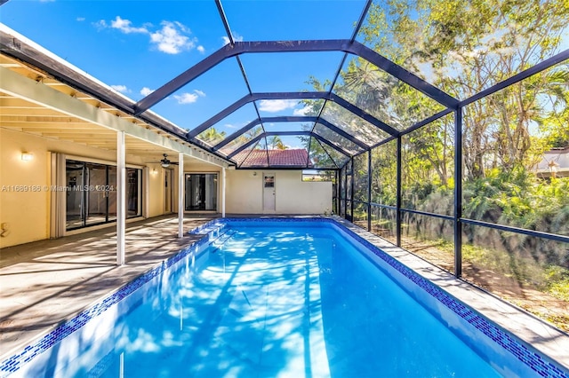 view of pool featuring a patio and glass enclosure