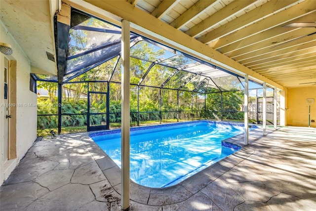 view of swimming pool with a lanai and a patio