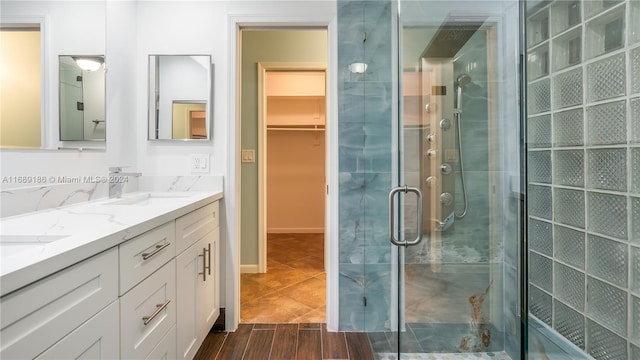 bathroom with vanity, an enclosed shower, and hardwood / wood-style flooring