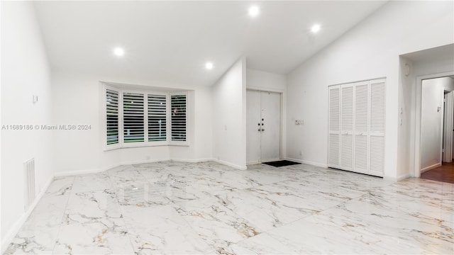 foyer entrance featuring lofted ceiling