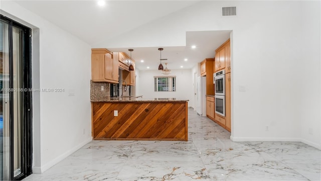 kitchen featuring stone counters, hanging light fixtures, vaulted ceiling, decorative backsplash, and kitchen peninsula