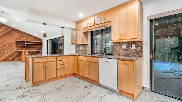 kitchen featuring hanging light fixtures, kitchen peninsula, white dishwasher, wooden walls, and light brown cabinetry