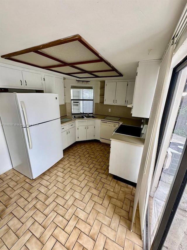 kitchen featuring white cabinetry, white appliances, and sink