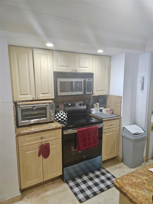 kitchen featuring tasteful backsplash, black range with electric stovetop, and light tile patterned floors