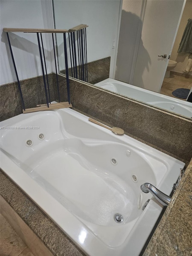 bathroom with a relaxing tiled tub