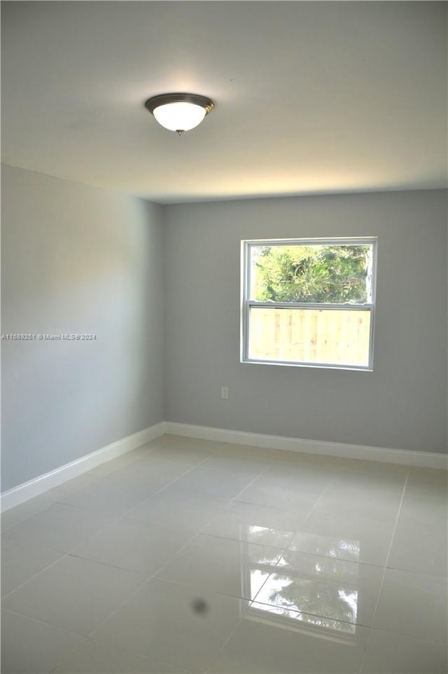 empty room with tile patterned flooring