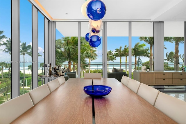 sunroom / solarium featuring a water view