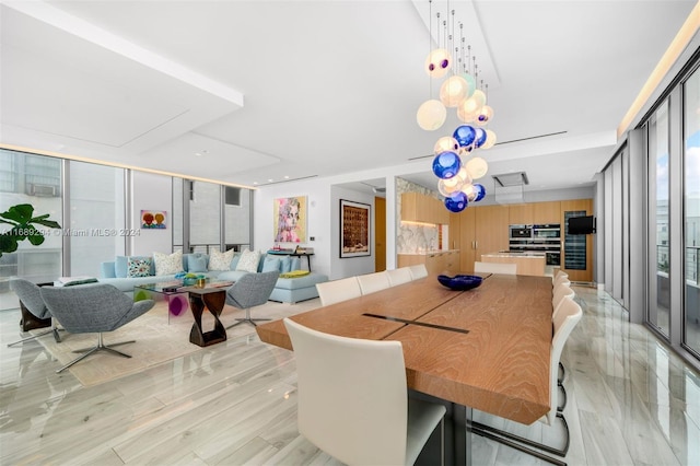 dining area with expansive windows and light wood-type flooring