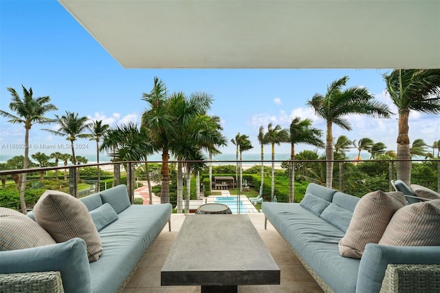 balcony with an outdoor living space and a water view