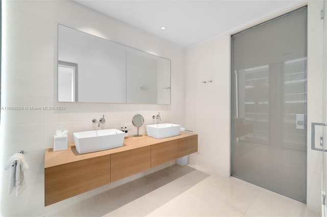 bathroom with tile patterned floors, vanity, and an enclosed shower