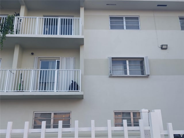 view of side of property with a balcony