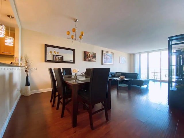 dining space featuring dark wood-type flooring and a chandelier