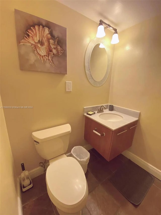 bathroom featuring vanity, tile patterned flooring, and toilet