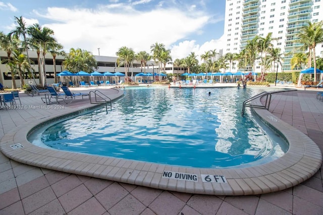 view of swimming pool featuring a patio area